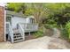 A backyard has a concrete patio and a wooden deck with steps that lead to a fenced yard at 611 Beaver Dam Rd, Raleigh, NC 27607