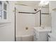 Full bathroom featuring tiled walls, a shower-tub combo, vanity with sink, and updated fixtures at 611 Beaver Dam Rd, Raleigh, NC 27607