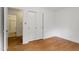 Bedroom with hardwood floors, closet, and access to an en-suite bathroom at 611 Beaver Dam Rd, Raleigh, NC 27607