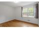 Bright bedroom with hardwood floors, large window, and neutral walls, creating a versatile space at 611 Beaver Dam Rd, Raleigh, NC 27607