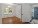 Bright dining area with hardwood floors, classic chandelier, and an open doorway to an adjacent room at 611 Beaver Dam Rd, Raleigh, NC 27607