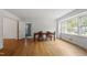 Sunlit dining room featuring hardwood floors, classic wood furniture, and large windows at 611 Beaver Dam Rd, Raleigh, NC 27607