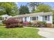 Charming single-story home with a beautifully landscaped front yard and inviting walkway leading to the front door at 611 Beaver Dam Rd, Raleigh, NC 27607