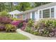 Inviting single story home featuring a brick accent, complemented by vibrant azaleas and lush greenery at 611 Beaver Dam Rd, Raleigh, NC 27607