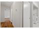 Hallway view featuring hardwood flooring, with laundry area and living room at the end of the hall at 611 Beaver Dam Rd, Raleigh, NC 27607