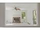 Bright living room boasts a fireplace, large window, and tiled floor, offering a cozy atmosphere at 611 Beaver Dam Rd, Raleigh, NC 27607
