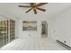Open living room features tile flooring, ceiling fan, and view into kitchen area, creating an airy and connected feel at 611 Beaver Dam Rd, Raleigh, NC 27607