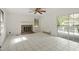 Living room featuring fireplace, large window, and sliding glass door, providing bright and open living space at 611 Beaver Dam Rd, Raleigh, NC 27607