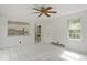 Spacious living room with tiled flooring, a ceiling fan, and views into kitchen and hall at 611 Beaver Dam Rd, Raleigh, NC 27607