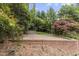 Brick patio with mature trees and foliage offers a private outdoor living space at 611 Beaver Dam Rd, Raleigh, NC 27607