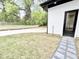 Side view of modern home with a new black door, fresh sod, gravel accents, and concrete parking at 622 Glascock St, Raleigh, NC 27604