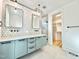 Modern bathroom with double vanity, stylish mirrors, geometric backsplash, and walk in closet at 622 Glascock St, Raleigh, NC 27604