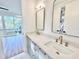 Elegant bathroom featuring double sink vanity, quartz countertop, stylish fixtures, and open bedroom view at 622 Glascock St, Raleigh, NC 27604