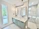 Modern bathroom with double vanity, stylish mirrors, geometric backsplash, and glass shower at 622 Glascock St, Raleigh, NC 27604