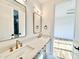 Bright bathroom featuring double sinks with quartz countertop, bronze faucets and modern lighting at 622 Glascock St, Raleigh, NC 27604