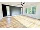 Spacious bedroom with hardwood floors, ceiling fan, and large windows offering scenic views at 622 Glascock St, Raleigh, NC 27604