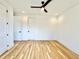 Spacious bedroom features hardwood floors, neutral walls, ceiling fan, and white doors and trim at 622 Glascock St, Raleigh, NC 27604