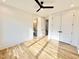 Bright bedroom with hardwood floors, modern ceiling fan, white walls, and views to adjoining bath at 622 Glascock St, Raleigh, NC 27604