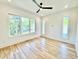 Bright bedroom featuring hardwood floors, large windows and a modern ceiling fan at 622 Glascock St, Raleigh, NC 27604