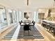 Dining room with a modern table set, striped rug, and adjacent kitchen with stainless steel appliances at 622 Glascock St, Raleigh, NC 27604