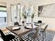 Elegant dining area boasts modern lighting, stylish table setting, and seamless transition to outdoor patio at 622 Glascock St, Raleigh, NC 27604