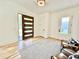 Inviting entryway with wood floors, a modern front door, and seating area with stylish pillows at 622 Glascock St, Raleigh, NC 27604