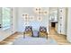 Beautiful entryway with hardwood floors, modern lighting, and view into a light-filled kitchen at 622 Glascock St, Raleigh, NC 27604