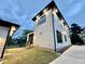 Twilight exterior view of modern, two-story home with white siding and a black roof and trim at 622 Glascock St, Raleigh, NC 27604
