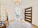 Bright foyer with wood floors, an attractive accent rug, and a glass paneled front door allowing for ample natural light at 622 Glascock St, Raleigh, NC 27604
