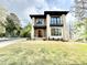 Daytime front exterior view of new build modern home with mixed materials: wood, stone, and siding at 622 Glascock St, Raleigh, NC 27604