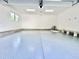 Spacious epoxy floored garage with white walls, storage area, and natural light at 622 Glascock St, Raleigh, NC 27604
