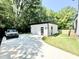 A detached garage with modern door design, side door, and spacious parking, surrounded by lush greenery at 622 Glascock St, Raleigh, NC 27604