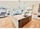 Open-concept kitchen with a large island, stainless steel appliances, and hardwood floors at 622 Glascock St, Raleigh, NC 27604