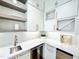 Kitchenette with white countertops, wine storage, and stainless steel appliances at 622 Glascock St, Raleigh, NC 27604