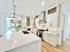 Modern white kitchen with a large quartz island, stainless steel appliances, and ample cabinet space at 622 Glascock St, Raleigh, NC 27604