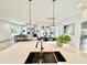 Open concept design with large island and sink area connecting the kitchen, dining, and living spaces at 622 Glascock St, Raleigh, NC 27604
