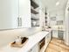 Bright kitchen with white cabinets, stainless steel appliances, and a marble countertop at 622 Glascock St, Raleigh, NC 27604