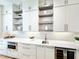 Modern kitchen with white cabinets, stainless steel appliances, and open shelving, perfect for entertaining at 622 Glascock St, Raleigh, NC 27604