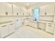Well-lit laundry room with white cabinets, ample counter space, and a modern sink at 622 Glascock St, Raleigh, NC 27604