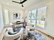 Bright office with large windows, hardwood floors, ceiling fan, modern desk, and an eye-catching accent rug at 622 Glascock St, Raleigh, NC 27604