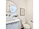 Charming powder room with modern fixtures, round mirror, and a white vessel sink at 622 Glascock St, Raleigh, NC 27604