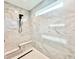 New glass enclosed shower with marble tile, shower bench, and sleek fixtures at 622 Glascock St, Raleigh, NC 27604