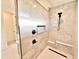 Stylish glass enclosed shower with marble tile, shower bench, and sleek fixtures at 622 Glascock St, Raleigh, NC 27604