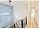 Stylish staircase with modern lighting fixtures and blue accent wall with decorative molding at 622 Glascock St, Raleigh, NC 27604