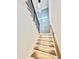 Stylish staircase with wood and white finishes, under-step lighting, and a modern metal railing at 622 Glascock St, Raleigh, NC 27604