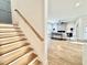 Modern staircase leading to an open living area with a fireplace and access to an outdoor patio at 622 Glascock St, Raleigh, NC 27604