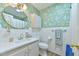 Bathroom with floral wallpaper, white tile, and modern fixtures, blending vintage charm with contemporary elegance at 775 Old Graham Rd, Pittsboro, NC 27312
