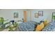 Bright bedroom with light wood floors, trendy decor, and a comfy chair enhance this room at 775 Old Graham Rd, Pittsboro, NC 27312