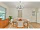 Dining room featuring wood floors, modern chandelier, and mid century modern cabinet at 775 Old Graham Rd, Pittsboro, NC 27312