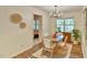Bright dining room with wood floors, modern light fixture, and decorative wall art at 775 Old Graham Rd, Pittsboro, NC 27312